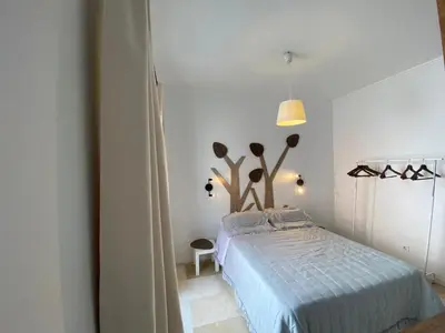 a bedroom with a bed in a white room at La Marchena in Jerez de la Frontera