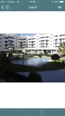 a picture of a building with a parking lot at Habitacion privada en piso compartido de dos habitaciones en urbanización con piscina y pista de padel in El Puerto de Santa María
