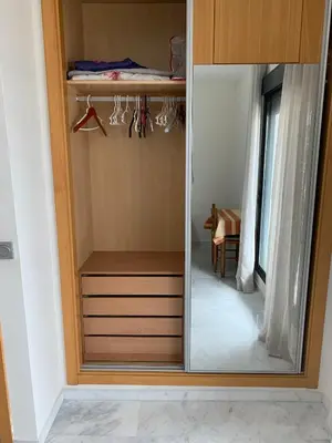a wardrobe with a mirror in a room at Habitacion privada en piso compartido de dos habitaciones en urbanización con piscina y pista de padel in El Puerto de Santa María