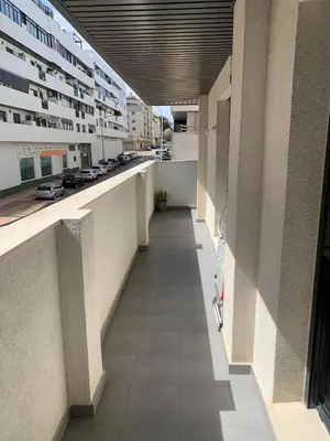 an empty hallway of a building with cars on the street at Habitacion privada en piso compartido de dos habitaciones en urbanización con piscina y pista de padel in El Puerto de Santa María