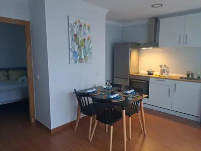 a kitchen with a table and chairs in a room at Villa Estrella in Jerez de la Frontera
