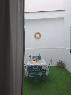 a table and chairs in a room with green grass at Villa Estrella in Jerez de la Frontera