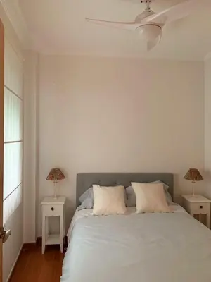 a bedroom with a white bed with two night stands at Villa Estrella in Jerez de la Frontera