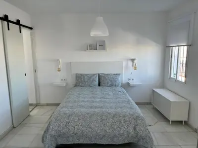 a bedroom with a bed in a white room at Ocón 2 in Lebrija