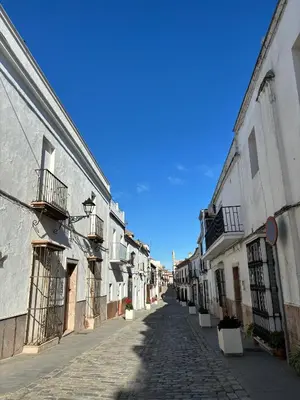 an empty street in a town with buildings at Ocón 2 in Lebrija