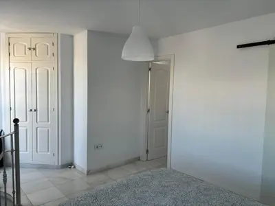 a room with white walls and a hallway with a door at Ocón 2 in Lebrija