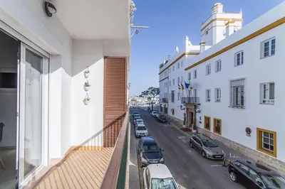 a kitchen with a refrigerator and a table and chairs at Secreto de Lola in El Puerto de Santa María