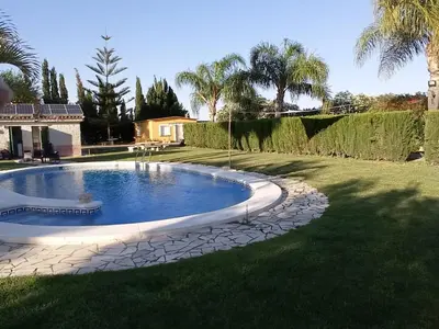 a swimming pool in the middle of a yard at Albanta in Chipiona