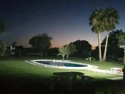 a small pool in a park with a picnic table at Albanta in Chipiona