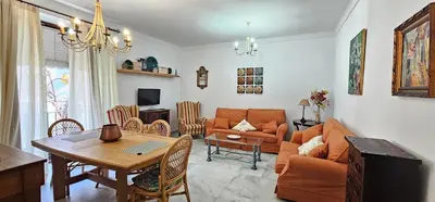 a living room with a couch and a table at Tartaneros Duplex by Sanlúcar Housing in Sanlúcar de Barrameda
