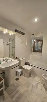 a bathroom with a toilet and a sink and a tub at Tartaneros Duplex by Sanlúcar Housing in Sanlúcar de Barrameda