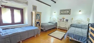 a bedroom with two beds and a window at Tartaneros Duplex by Sanlúcar Housing in Sanlúcar de Barrameda