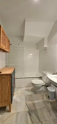 a bathroom with a toilet and a sink at Tartaneros Duplex by Sanlúcar Housing in Sanlúcar de Barrameda