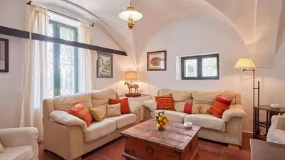 a living room with two couches and a table at El Membrillo casa rural in Arcos de la Frontera