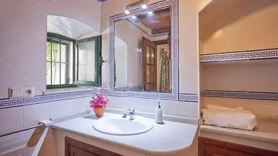 a bathroom with a sink and a mirror at El Membrillo casa rural in Arcos de la Frontera