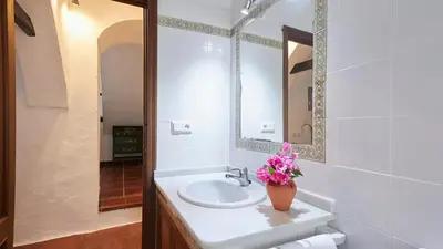 a bathroom with a sink and a mirror at El Membrillo casa rural in Arcos de la Frontera