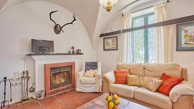 a living room with a couch and a fireplace at El Membrillo casa rural in Arcos de la Frontera