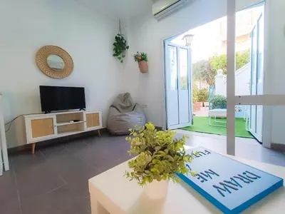a living room with a tv and a table at Sunset Puerto Sherry in El Puerto de Santa María