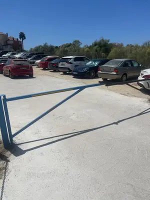 a parking lot with many cars parked in it at Sunset Puerto Sherry in El Puerto de Santa María