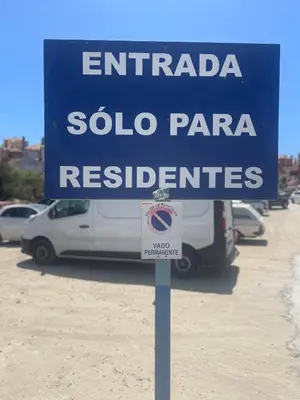 a blue sign in front of a parking lot at Sunset Puerto Sherry in El Puerto de Santa María