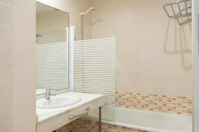 a bathroom with a sink and a mirror at Apartoyou - Estudio Pink in El Puerto de Santa María