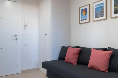 a bedroom with a mirror and a bed and a window at Apartoyou - Estudio Pink in El Puerto de Santa María