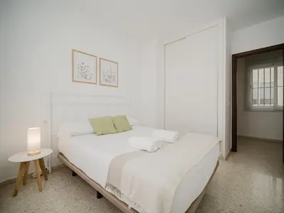 a bedroom with two beds with blue and white sheets at Sibs Sanlucar Marisma - Renovado Centro Ideal Familias in Sanlúcar de Barrameda