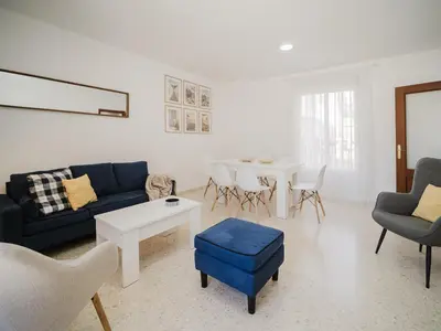 a white dining room with a white table and chairs at Sibs Sanlucar Marisma - Renovado Centro Ideal Familias in Sanlúcar de Barrameda
