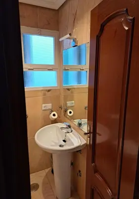 a small bathroom with a sink and a shower at Encanto Urbano: Piso céntrico totalmente equipado in Lebrija