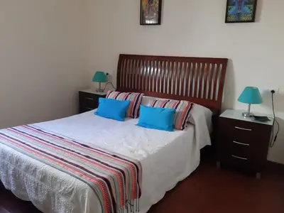 a bedroom with a bed with two blue pillows at La Perla de Cádiz by Gades Gestión in Cádiz