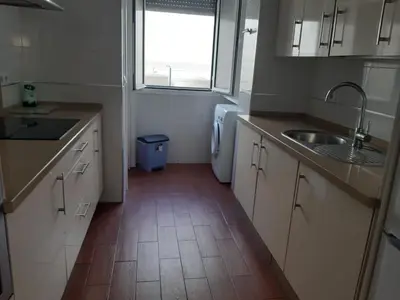 a kitchen with a sink and a washing machine at La Perla de Cádiz by Gades Gestión in Cádiz