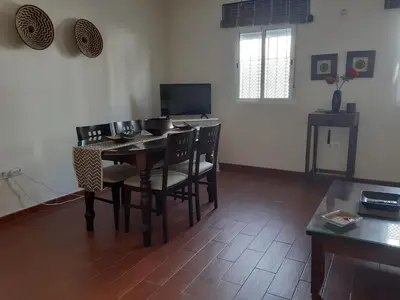 a living room with a dining room table and chairs at La Perla de Cádiz by Gades Gestión in Cádiz