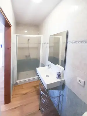 a bathroom with a sink and a mirror at Sanlucarsun Apartamento frente al mar in Sanlúcar de Barrameda