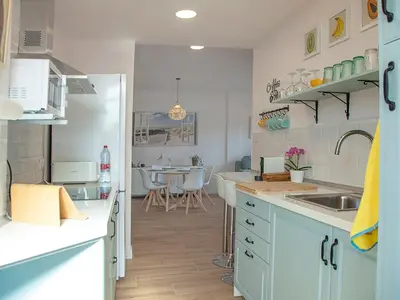 a kitchen with a sink and a counter top at Sanlucarsun Apartamento frente al mar in Sanlúcar de Barrameda