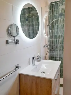a bathroom with a sink and a shower at Sanlucarsun Apartamento frente al mar in Sanlúcar de Barrameda