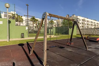 an old swing set in a park at Allo Apartments Europa II Parking Piscina Padel 4 Habitaciones in Jerez de la Frontera
