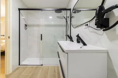 a bathroom with a shower and a sink at Allo Apartments Europa II Parking Piscina Padel 4 Habitaciones in Jerez de la Frontera