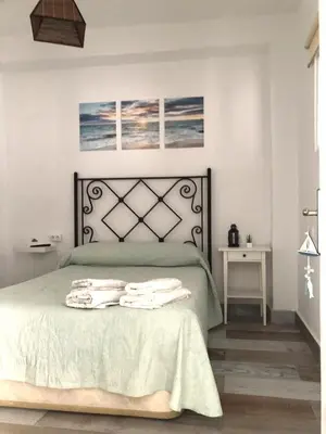 a bedroom with a bed with towels on it at Céntrico Rota Beach. in Rota