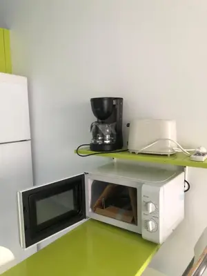 a microwave oven sitting on top of a counter at Céntrico Rota Beach. in Rota