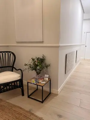 a living room with a chair and a table at Apartamentos Corredera 2 in Arcos de la Frontera