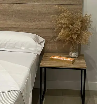 a table with a plate of food on it next to a bed at Apartamentos Corredera 2 in Arcos de la Frontera