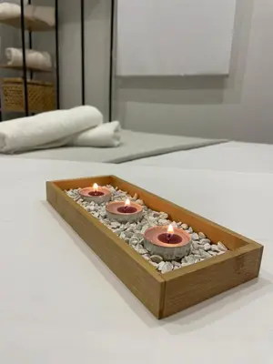 a wooden tray with three candles sitting on a table at Apartamentos Corredera 2 in Arcos de la Frontera