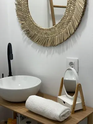 a bathroom with a white sink and a mirror at Apartamentos Corredera 2 in Arcos de la Frontera
