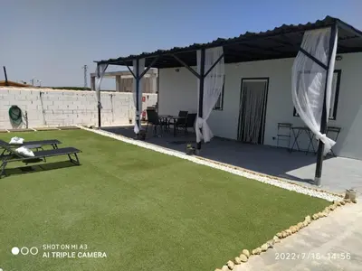 a patio with a tent and a grass yard at Casa, Sueños del Sur in Chiclana de la Frontera