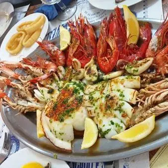 a plate of food with shrimp and seafood on a table at Casa, Sueños del Sur in Chiclana de la Frontera