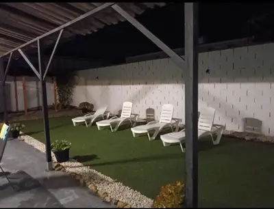 a group of white chairs sitting on a lawn at Casa, Sueños del Sur in Chiclana de la Frontera