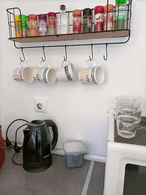a kitchen with a tea pot and cups on a shelf at Casa, Sueños del Sur in Chiclana de la Frontera