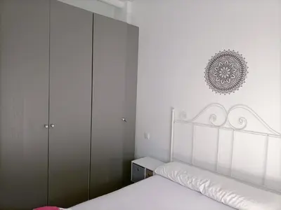 a white bedroom with a white bed and cabinets at Casa, Sueños del Sur in Chiclana de la Frontera
