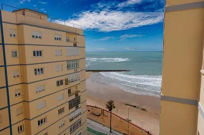 a view of the beach from a building at Apartamento Playa Santa María del Mar in Cádiz