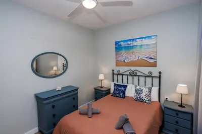 a bedroom with a bed and a ceiling fan at Apartamento Playa Santa María del Mar in Cádiz